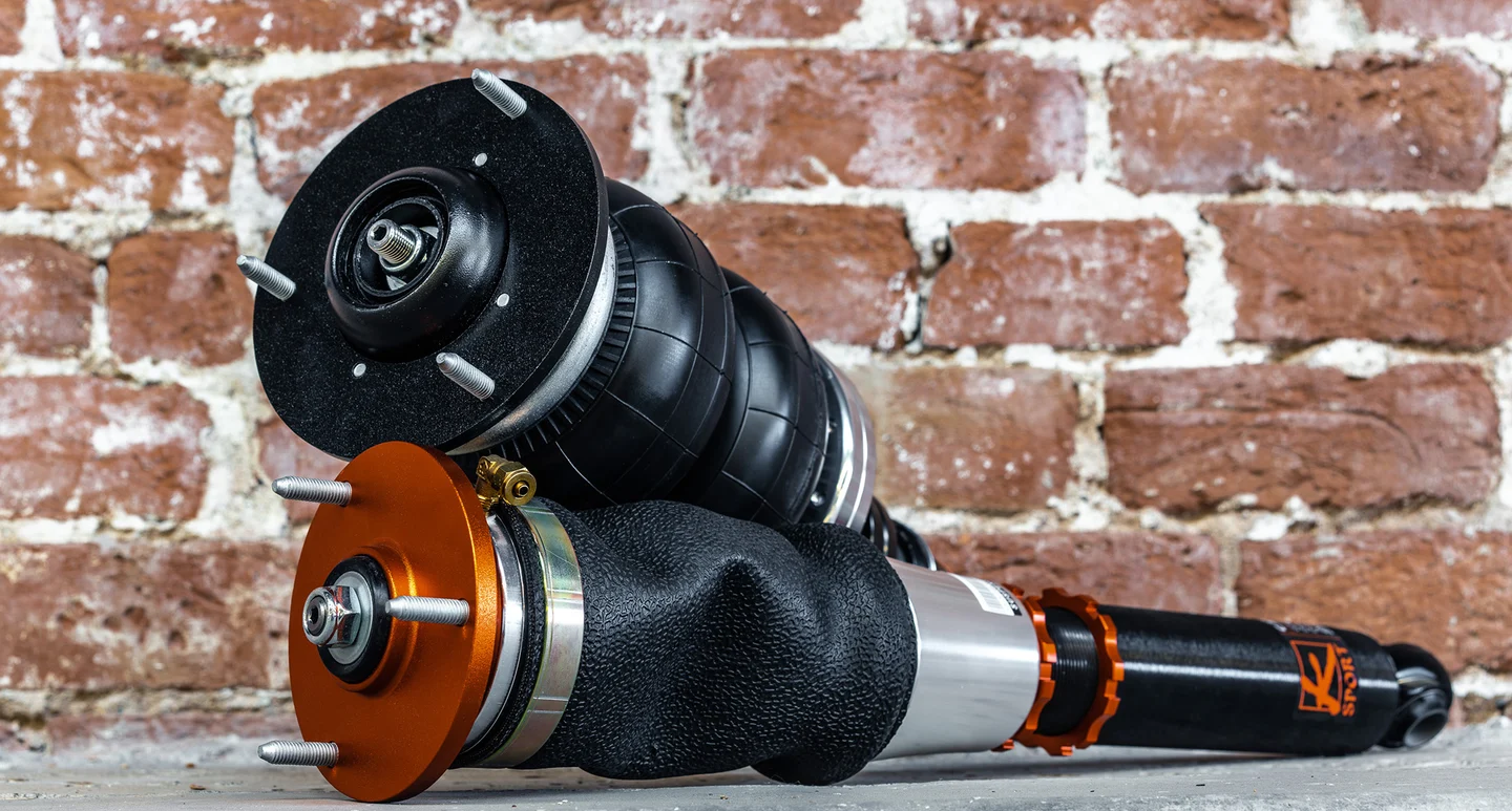 Genuine KSport Airtech family suspension photographed against brick