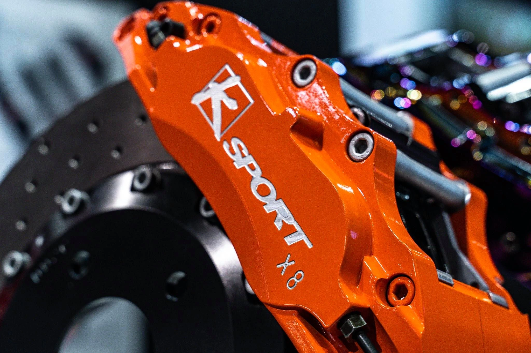 Orange KSport x8 caliper and brake rotor on display at SEMA 2019